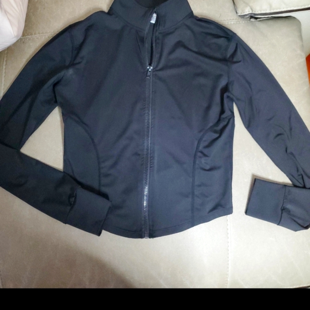 Medium 88% Nylon and 12% spandex zip front  long sleves cute with free sweater